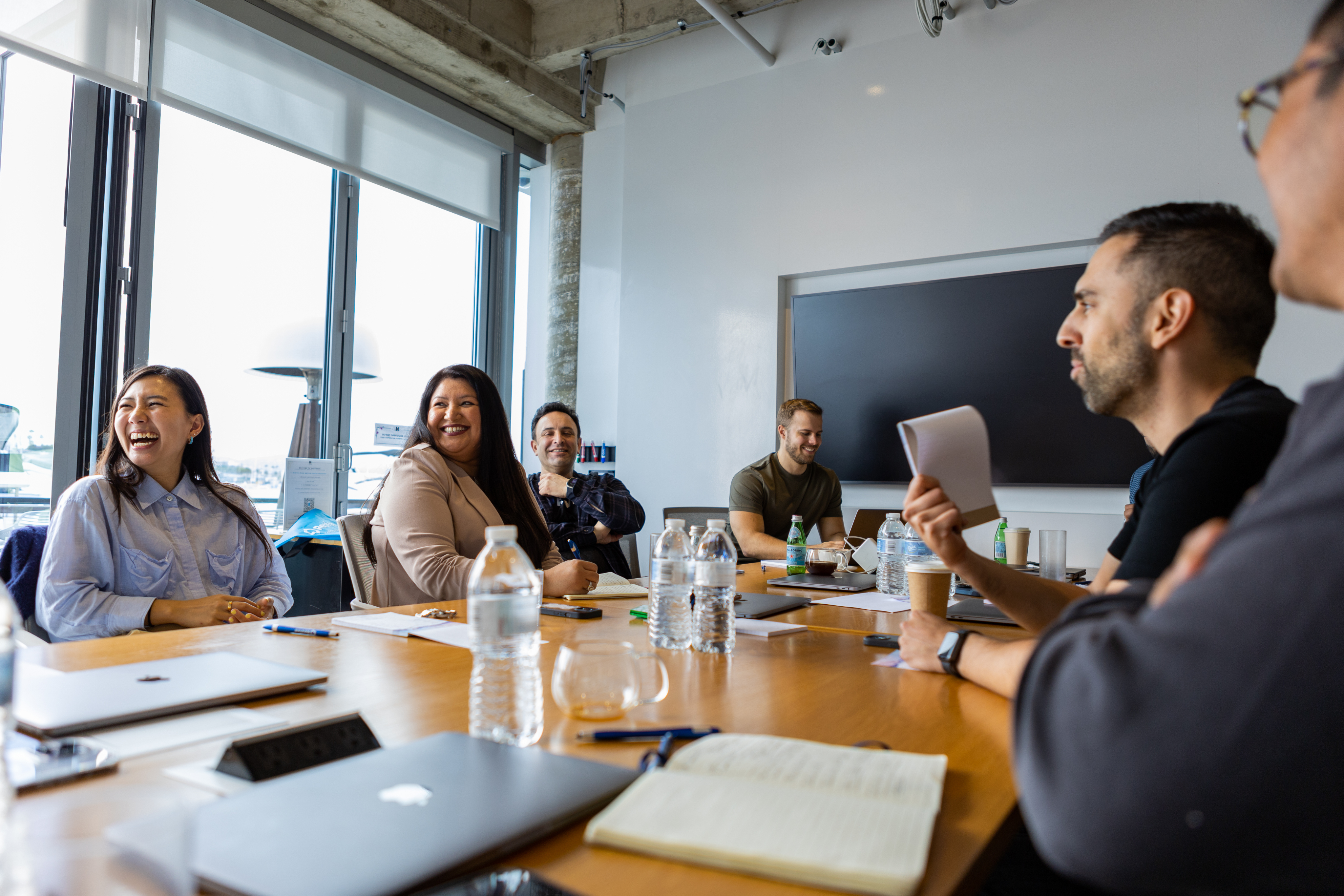 Revive team laughing around a conference table